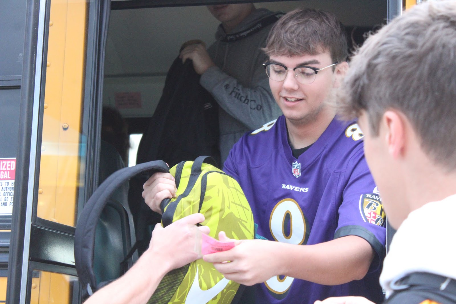 Seth Deloe, a senior CRANA member, helps unload bookbags from buses (Photo by Rylee Coe/Student contributor) 